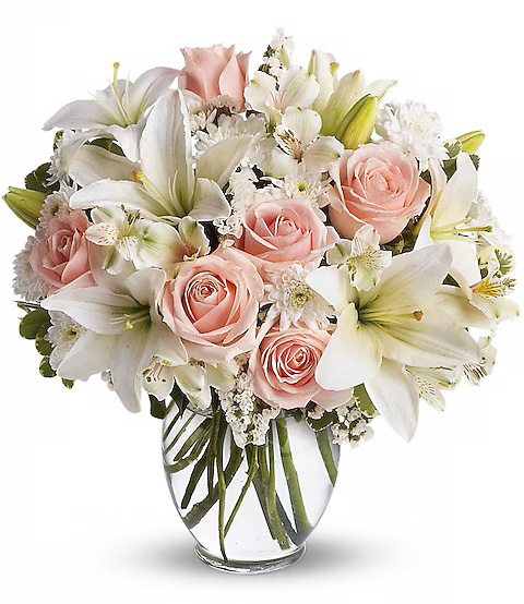 Vase arrangement with lilies and roses from the best flower shop in Paris.