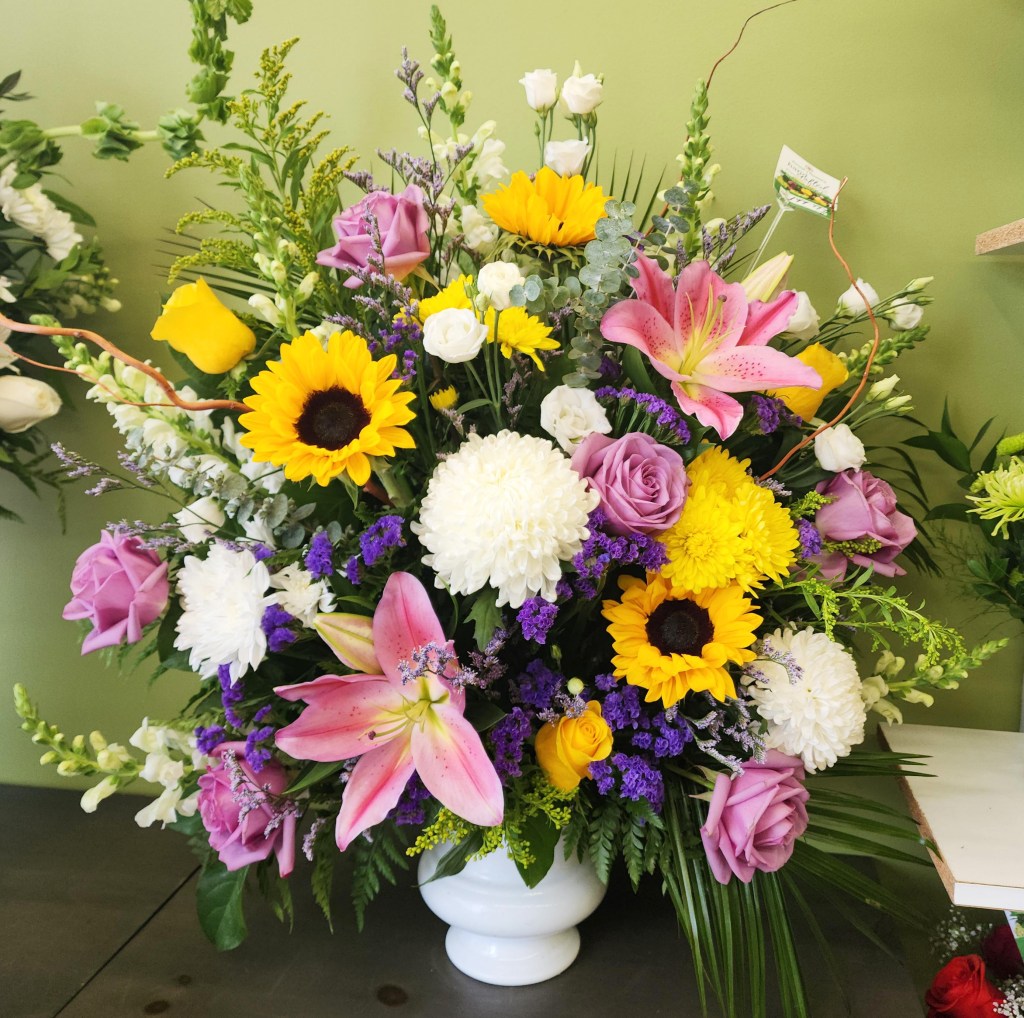 Sympathy flower arrangement for a funeral in Paris ready for a the flower delivery.