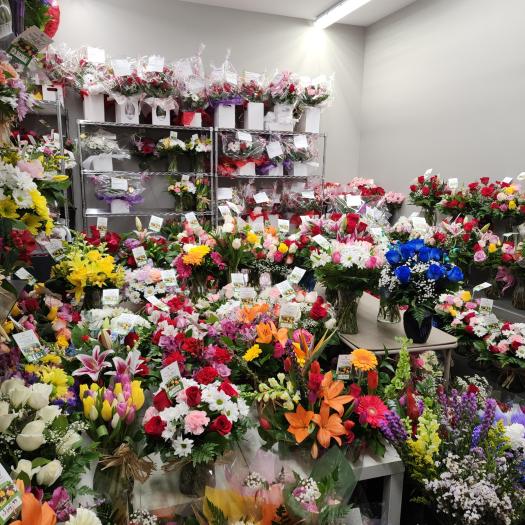 Fully stocked florist walk-in cooler filled with ready-made Valentineโs Day flower arrangements, bouquets, and roses at Forest of Flowers in Brantford and Paris, Ontario.